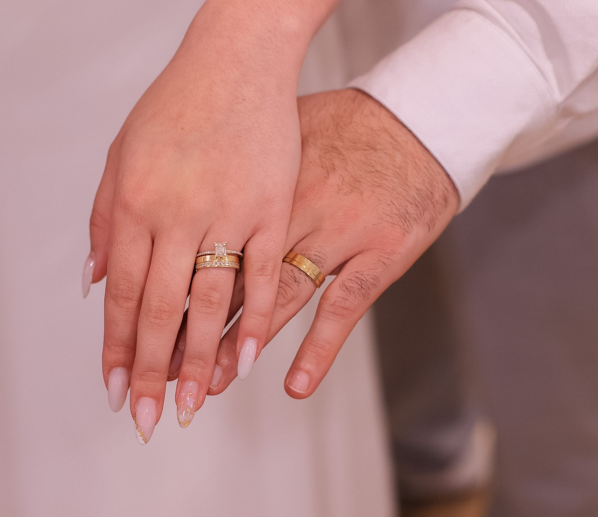 Rings on her hand over his